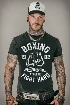 a man with tattoos and piercings wearing a black t - shirt that says old school