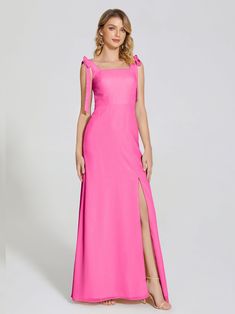 a woman in a bright pink dress with one side slited and the other side split open