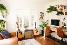 a living room filled with furniture and lots of plants