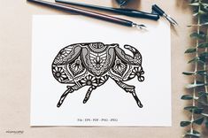 a drawing of an elephant with intricate patterns on it's body and legs, sitting next to some pens