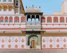 an ornate building with red and white tiles on it