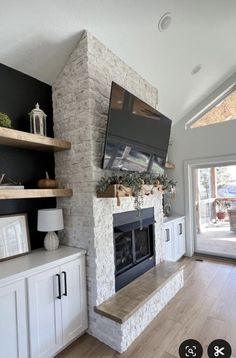 a living room filled with furniture and a flat screen tv mounted on the wall above a fireplace