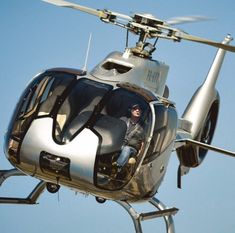 a man sitting in the cockpit of a helicopter