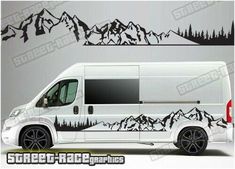 a white van with mountains and trees painted on it's side, in front of a gray background