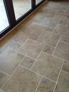 a tile floor in front of a glass door