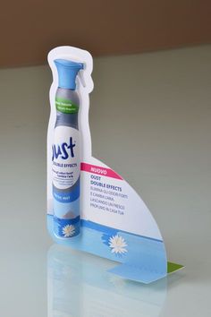 a bottle of just toothpaste sitting on top of a table