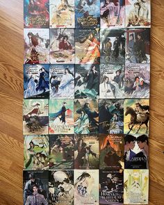 an assortment of anime posters on a wooden floor