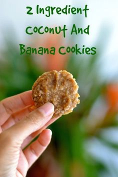 a hand holding a cookie with the words 2 ingredient coconut and banana cookies