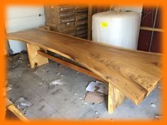 a large wooden bench sitting inside of a warehouse