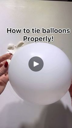 two hands holding a white ball with the words how to tie balloons properly on it