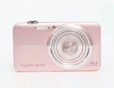 a pink camera sitting on top of a white table