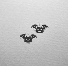 two bats with faces drawn on them