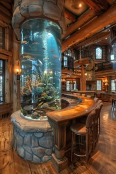 a fish tank in the middle of a bar with stools and tables around it