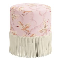 a pink and white hat with tassels on the bottom, sitting on top of a