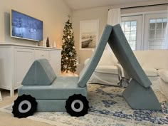 a living room filled with furniture and a christmas tree