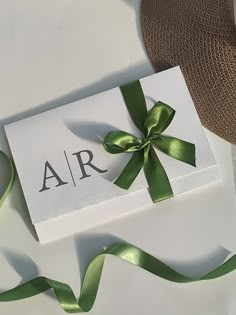 a white box with a green ribbon tied around it and the word air on it