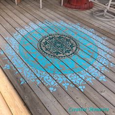 a wooden deck with blue and white designs on it