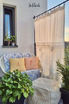 a balcony with plants and potted plants on it