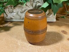 a wooden box sitting on top of a wooden table next to a potted plant