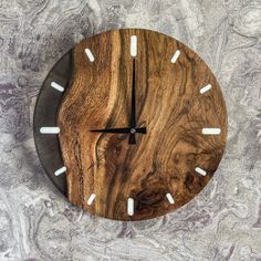 a clock made out of wood with white candles on the hands and numbers in the middle