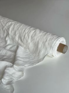 a roll of white fabric on top of a table