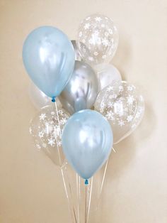 blue and white balloons are in a vase