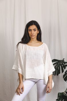 Beautiful cotton top with a textured finish. Wing sleeves Free size Relaxed White Cotton Top, Relaxed White Tops For Vacation, White Relaxed Fit Top, Chic Relaxed Fit Tunic Top, Off White Cotton Short Sleeve Blouse, White Crew Neck Blouse For The Beach, White Tunic Tops For Spring, White Cotton Tunic Shirt, Chic White Linen Blouse