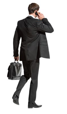 a man in a suit and tie talking on a cell phone while holding a briefcase