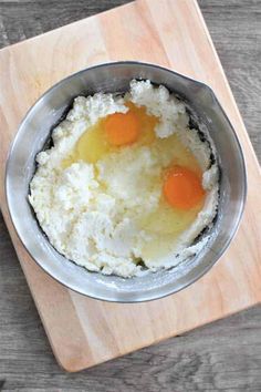 two eggs are in the middle of mashed potatoes