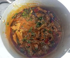 a pot filled with meat and vegetables on top of a stove