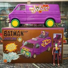 a purple toy van with batman figures on it's roof and in the back