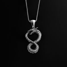 This stunning Ouroboros Silver Necklace is a must-have for any mythology enthusiast. The intricate dragon symbol pendant is beautifully designed and crafted with exquisite detail. Made from high-quality silver, this necklace is not only a fashion statement but also carries deep symbolic meaning. The Ouroboros, symbolizing infinity and the cycle of life, will add a touch of mystique and elegance to any outfit. Make a bold statement with this unique and meaningful piece of jewelry. This elegant si Dragon Symbol, The Ouroboros, Necklace Dragon, Mythology Jewelry, Jewelry Birthday, Birthday Jewelry Gift, Silver Rings Handmade, Unique Necklaces, Elegant Gift