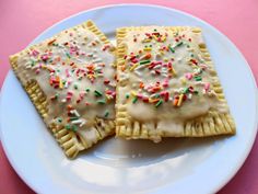 two pastries on a plate with sprinkles