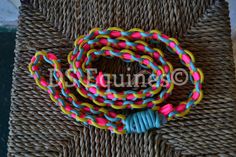 multicolored bracelets are sitting on a wicker mat with the word do fun written in it