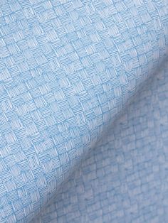 a close up shot of a blue and white woven material with small squares on it