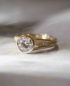 a close up view of a gold ring with a diamond on the bottom and side