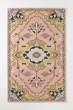 a pink rug with an ornate design on it