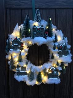 a wreath decorated with lights and fake trees