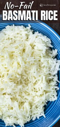 a blue bowl filled with basmati rice on top of a wooden table