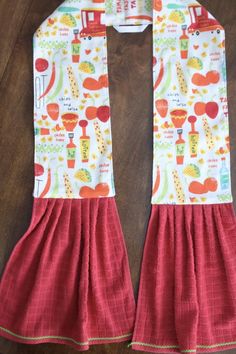 a red and white apron on top of a wooden table