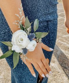 a close up of a person wearing a flower wrist corsage