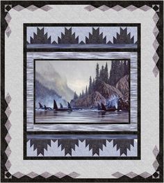 a quilt with an image of boats on the water and mountains in the back ground