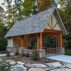 a small house with a covered porch and stone walkway