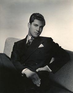 a man in a suit sitting on a couch