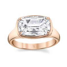 an 18k rose gold ring with a square cut diamond in the center and shoulders