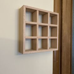 a wooden shelf mounted to the side of a wall