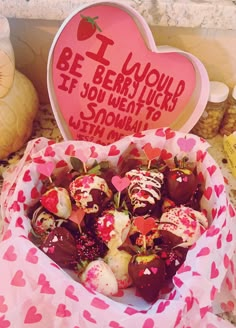 a bowl filled with chocolate covered strawberries next to a valentine's day sign