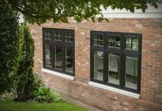 a brick building with double hung windows on the side