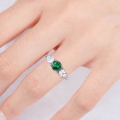 Make your style known with our breathtaking Ada emerald ring. Made on a base of Sterling Silver 925 and finished with a beautiful center emerald, this bold contrast will add a unique luxury to any outfit. Plus, our gorgeous CZ crystals further accentuate the shine, giving you a design you’ll simply adore. ✦ DETAILS ✦✧ Handcrafted ✧ 0.75 Carat center stone✧ Emerald and cz crystals ✧ Sizes 3.5-11✧ Rose gold over sterling silver 925, gold over sterling silver 925, or sterling silver 925 Luxury Green Crystal Ring In Open Ring Style, Dazzling Emerald Ring For Anniversary, Dazzling Green Emerald Ring Gift, Dazzling Green Ring Jewelry, Emerald Solitaire Ring For May Birthstone, May Birthstone Emerald Solitaire Open Ring, May Birthstone Open Emerald Ring, Fine Jewelry, Dazzling Emerald Jewelry For Promise Ring, Dazzling Green Emerald Ring With Prong Setting