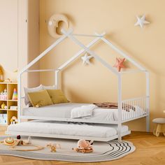 a child's bedroom with a white bed and toys on the floor in front of it